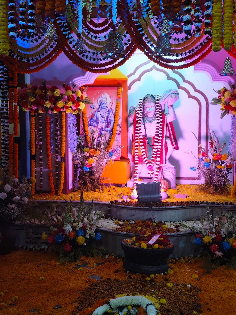 Temple & Worship: A shrine decorated with flowers around a Shiva lingam