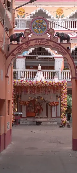 Our Premises: A courtyard archway with elephant motifs, leading to a decorated shrine