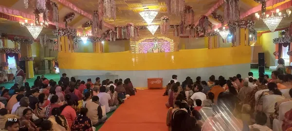 Community: A decorated hall with a large audience seated for a programme