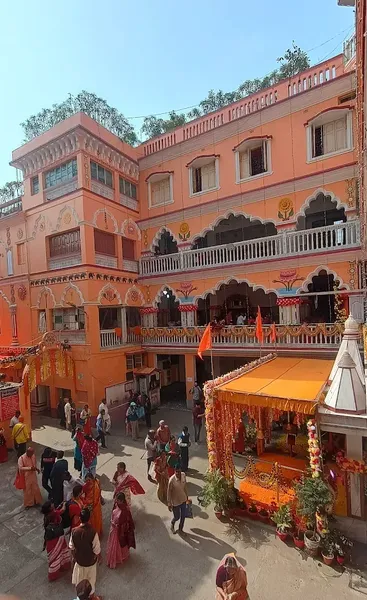 Festivals & Observances: A decorated pavilion in the courtyard during a festival, with devotees gathering