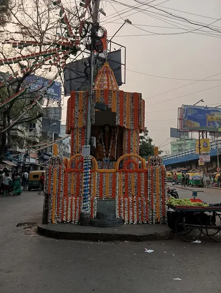 Temple & Worship: A roadside shrine decorated with garlands for a festival