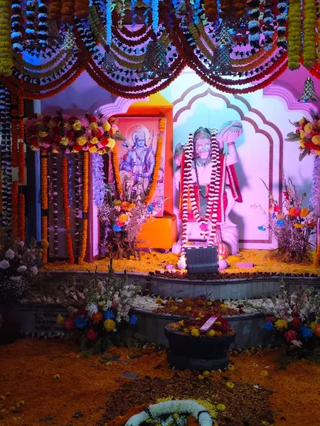 Temple & Worship: A shrine decorated with flowers around a Shiva lingam