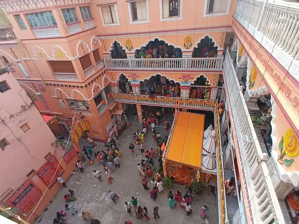 Our Premises: The courtyard seen from an upper balcony during a festival gathering