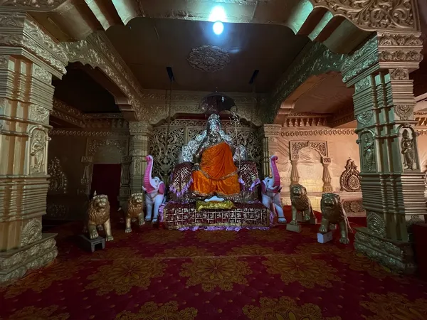 Temple & Worship: The temple sanctum, with the shrine of Acharya Swami Pranavananda flanked by carved lions and elephants